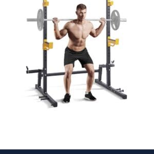 Man squatting with barbell in power rack.
